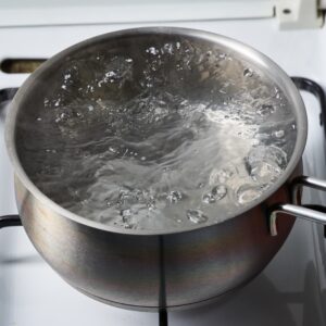 Boiling water in a kettle. A traditional method of water purification, though not recommended as the primary method due to limitations.