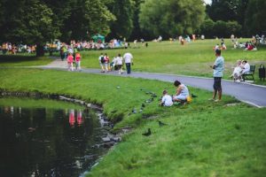 people walking in Park near a lake